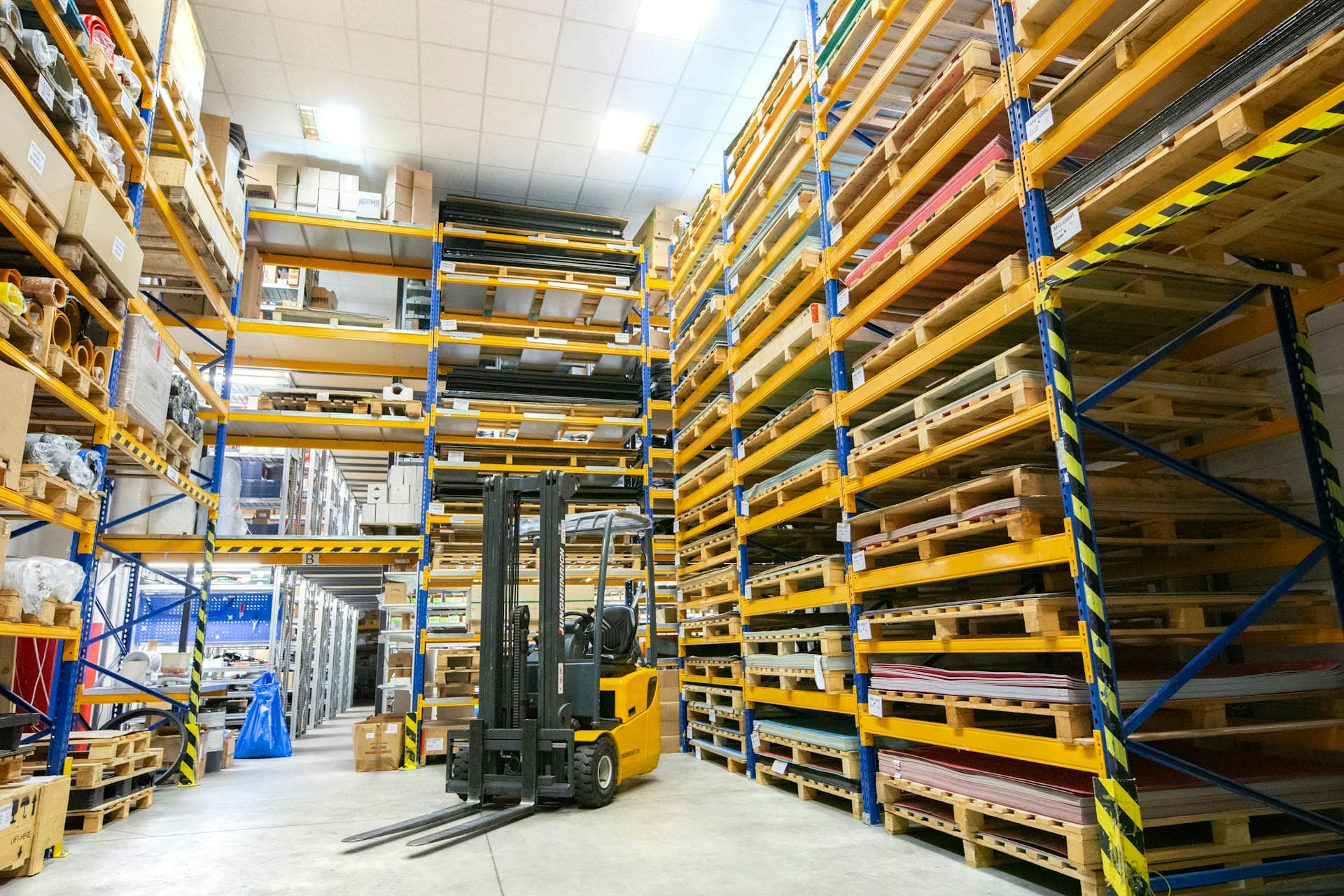 A vast warehouse interior stocked with agricultural equipment